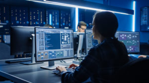 Smart Female IT Programer Working on Desktop Computer in Data Center System Control Room. Team of Young Professionals Doing Code Programming photo of female IT programer