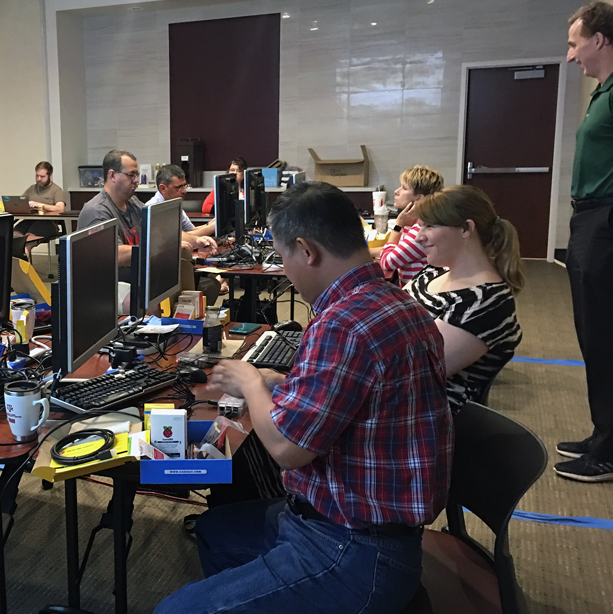 Teachers building Raspberry Pis in an onsite Texas A&M cybersecurity summer camp