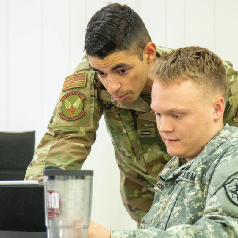 cadets working together on laptop